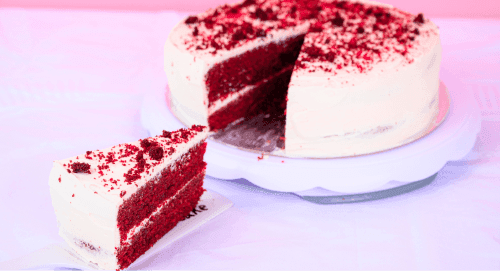 A cake with a slice being pulled