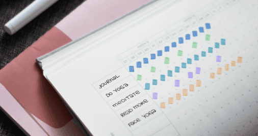 A person tracking habits in a journal